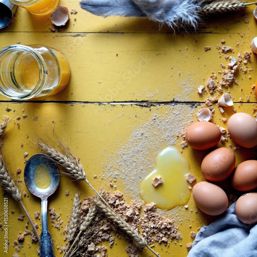 Rustic baking ingredients on yellow wood table