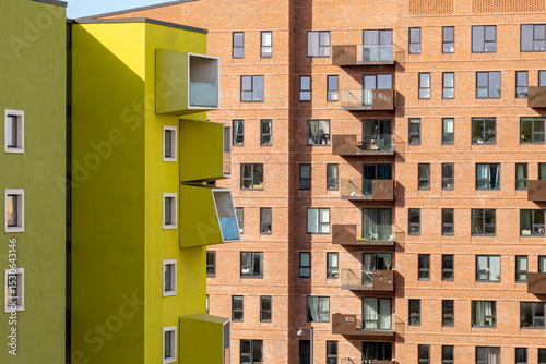 Modern residential facade with balconies and green detail, Ørestad, Copenhagen, clean architectural pattern and urban development for commercial background photo