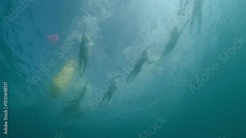 Athletes swimming underwater during triathlon competition