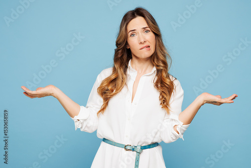 Young confused employee business woman corporate lawyer wear shirt classic formal clothes work in office shrugging shoulders looking puzzled isolated on pastel light blue background studio portrait.