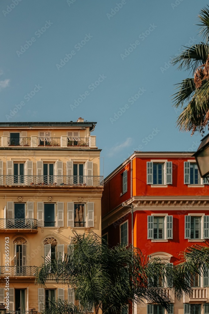 Naklejka premium Colorful European buildings with palm trees.