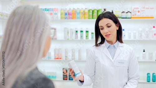 Fotografía Female pharmacist advising cosmetic product to female client