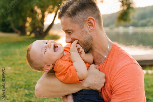 Father And Baby Laughing Together Outdoors