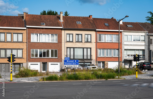 Houses in a row on a traffic intersection of national road N 202 in Strombeek Bever, Flemish Brabant Region, Belgium
