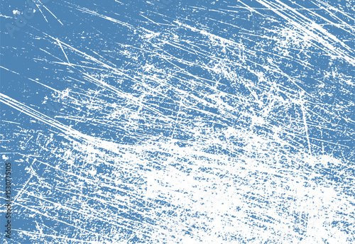 Abstract blue texture with white scratch marks for artistic backgrounds or digital design elements. a grunge effect is achieved with this rough surface.