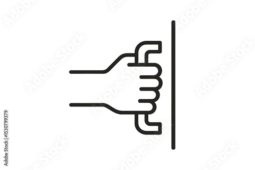 Hand gripping a door handle during daylight in an indoor setting near a wall