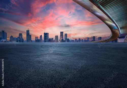 Asphalt road and bridge with city skyline in Shanghai at sky sunset, China. 