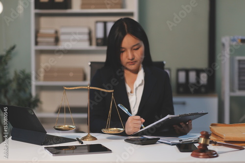 Judge gavel with Justice lawyers having team meeting at law firm background. Concepts of Law and Legal services.