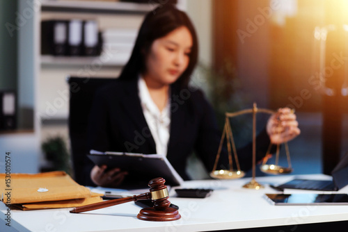 Judge gavel with Justice lawyers having team meeting at law firm background. Concepts of Law and Legal services.