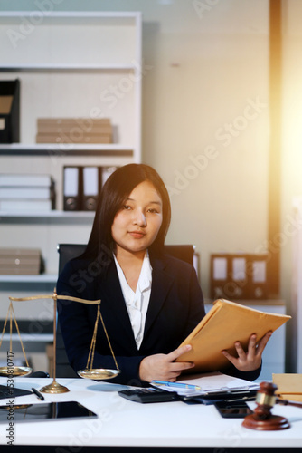 Judge gavel with Justice lawyers having team meeting at law firm background. Concepts of Law and Legal services.