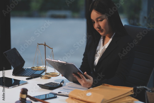 Judge gavel with Justice lawyers having team meeting at law firm background. Concepts of Law and Legal services.