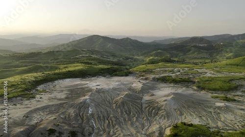 Buzău's Boiling Mud Volcanoes.
This aerial video captures a surreal landscape in Buzău County, Romania, showcasing the unique and otherworldly Muddy Volcanoes. 