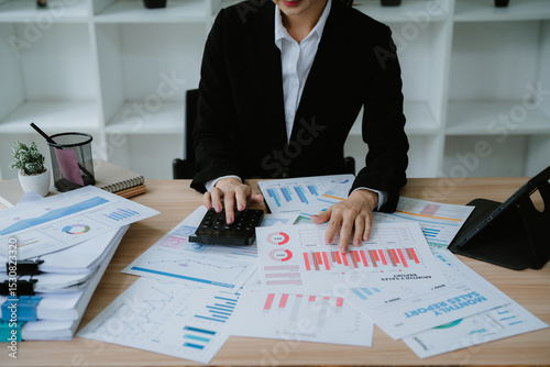 Close up businessman hand using calculator to budgeting and tax calculation monthly expenses. budget management and accounting on table. Business finance accounting banking concept.