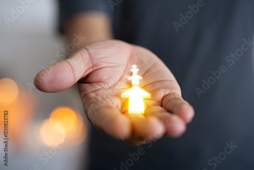 Glowing House Icon in Hand Symbol of Hope, Home, and New Beginnings, Representing Shelter, Security, and Family