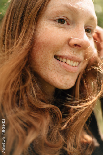 Portrait of a red-haired smiling girl