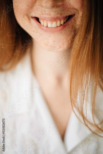 Redhead girl with freckles smiling