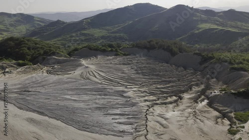 Buzău's Boiling Mud Volcanoes.
This aerial video captures a surreal landscape in Buzău County, Romania, showcasing the unique and otherworldly Muddy Volcanoes. 