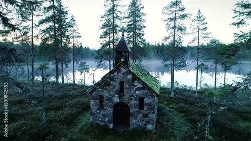 Ladoga lake reflects on a stone church nestled in the Finnish forest. Suitable for travel guides, nature magazines, and postcards.
