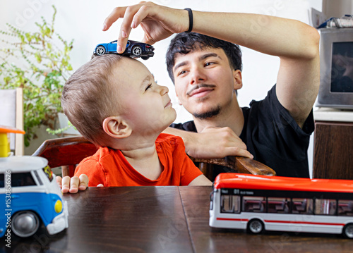  Two Jewish Half-brothers - 2,5 and 17 year old are playing with model cars.