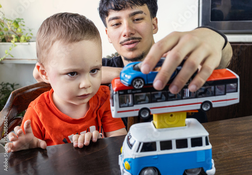  Two Jewish Half-brothers - 2,5 and 17 year old are playing with model cars.