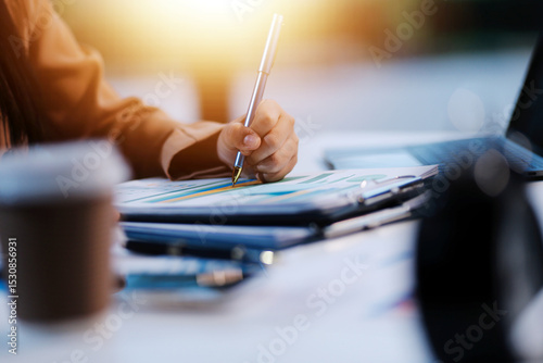 Business woman accountant working audit and calculating expense financial annual financial report balance sheet statement, doing finance making notes on paper checking document.