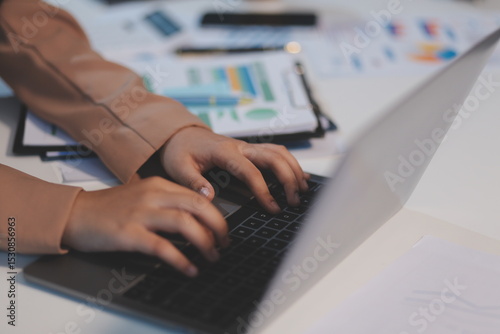 Business woman accountant working audit and calculating expense financial annual financial report balance sheet statement, doing finance making notes on paper checking document.