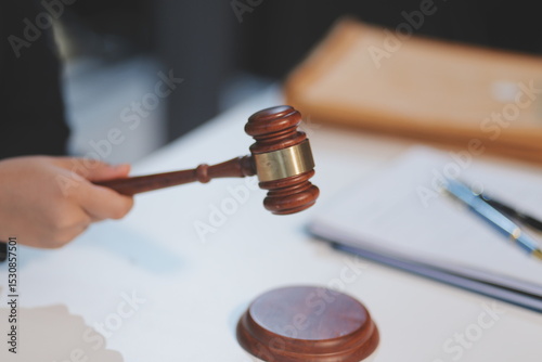 Judge gavel with Justice lawyers having team meeting at law firm background. Concepts of Law and Legal services.