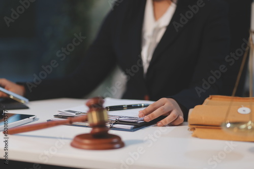 Judge gavel with Justice lawyers having team meeting at law firm background. Concepts of Law and Legal services.