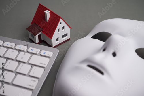 House, keyboard computer, white mask scammer on gray background. Real estate, property, land, rental, mortgage closing scams concept. Protect money from real estate scams when buying, rental a home.