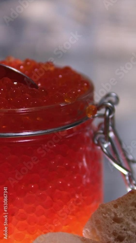 Man's hands takes a spoonful of red caviar and puts it on a piece of bread. Editing two frames. Close-up. . High quality 4k footage