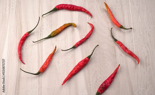 Fresh long Indian green and red chillies on beautiful background. Organic Indian spices for hot and spicy cuisine. 