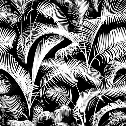 Seamless pattern with white palm tree branches isolated on a black background. Desert and tropical houseplants. 
