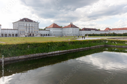 A wide-angle landscape view of the expansive formal lake within the magnificent Nymphenburg Palace grounds in Munich