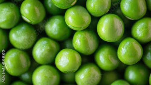 Vibrant green peas closely packed create a glossy and fresh display of nature's bounty in a delightful macro perspective