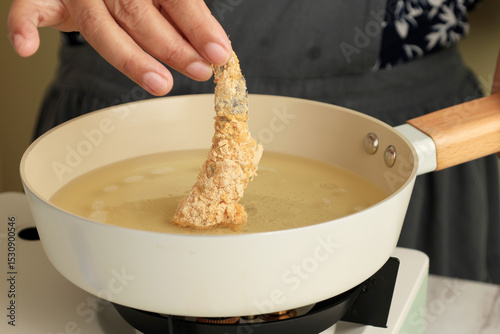 Chef frying prawns in oil photo