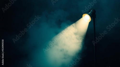 Spotlight illuminating a dark, misty stage, creating an atmospheric scene for performances