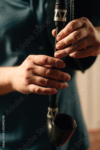 Hands of a bagpiper playing the bagpipes