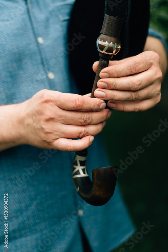 Hands of a bagpiper playing the bagpipes