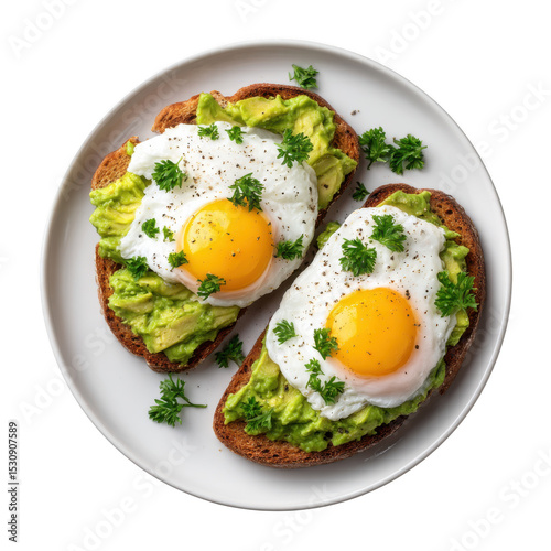 Two avocado toasts topped with fried eggs and parsley on a white plate presented from above