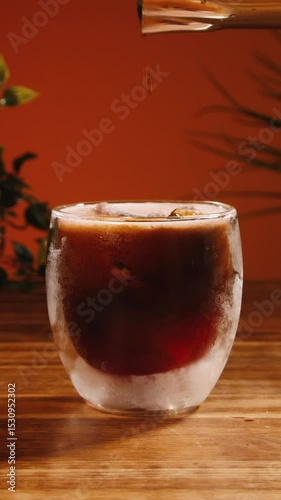 Adding espresso into red tonic with ice