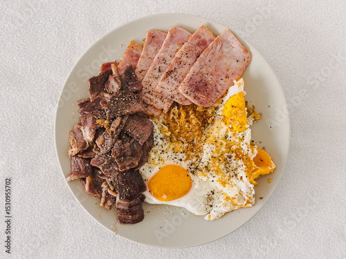 High protein keto meal of pork beef and fried eggs served on the dish.
