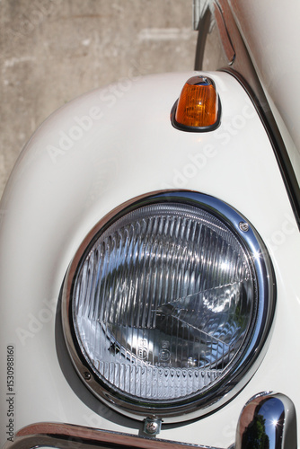 oldtimer car front wing with headlight and indicator on  white vehicle
