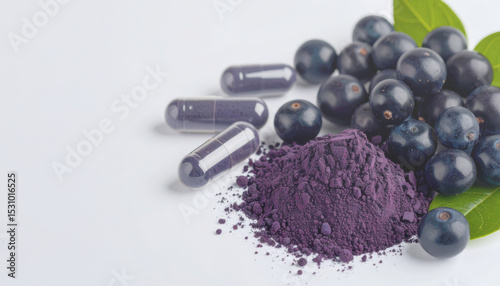 Acai berries with purple powder and capsules.