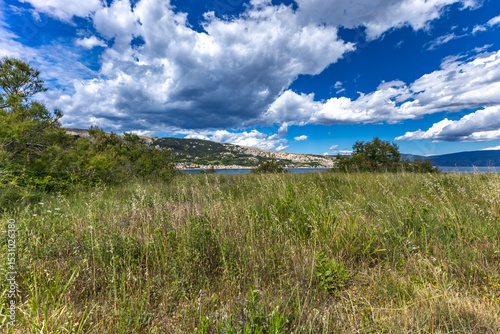 Fototapeta Naklejka Na Ścianę i Meble -  Hiking trail leading from the beach in Baska to the Bag mountain, city panorama seen from above,