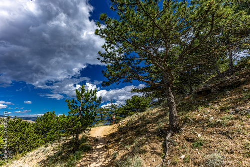 Fototapeta Naklejka Na Ścianę i Meble -  Hiking trail leading from the beach in Baska to the Bag mountain, city panorama seen from above,
