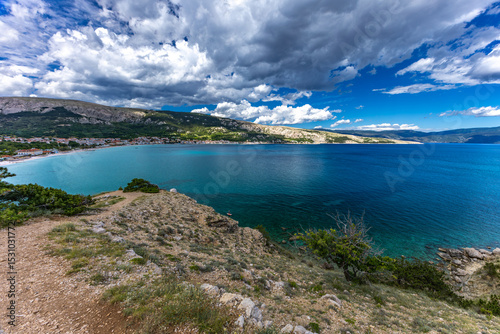 Hiking trail leading from the beach in Baska to the Bag mountain, city panorama seen from above, photo
