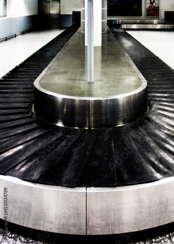 An empty baggage carousel in an airport.