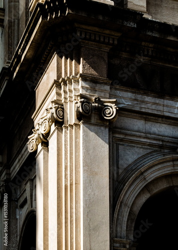Architectural detail of a building corner with columns and decorative elements.