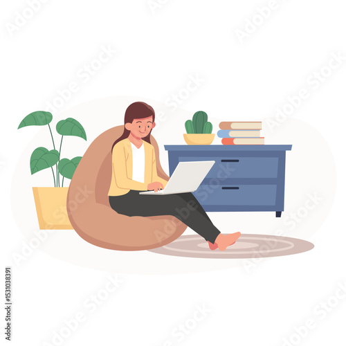 Woman working on laptop sitting in beanbag chair with plant and cabinet