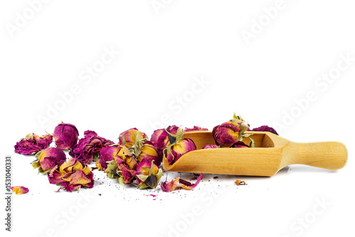 Rose flower dry tea with wooden scoop isolated on a white background